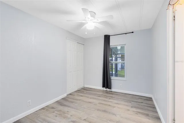 wooden floor in an empty room with a window