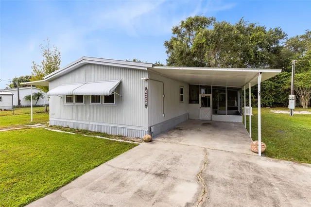 a view of an house with backyard space and balcony