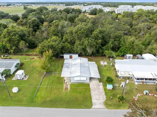 an aerial view of a house with a yard basket ball court