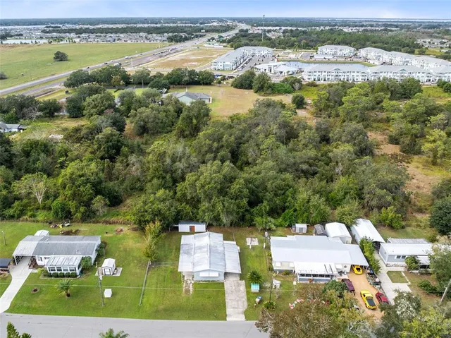 an aerial view of residential houses with outdoor space and river