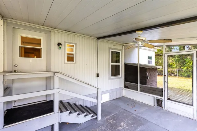 a view of a hallway with white walls and windows