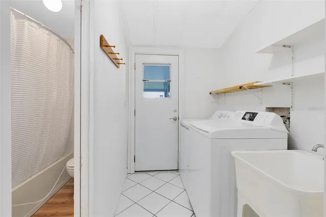 a bathroom with a sink and a washer dryer