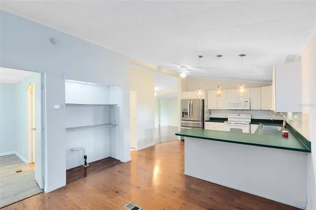 a kitchen with kitchen island stainless steel appliances a sink and a counter top