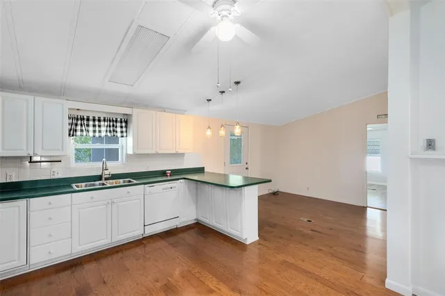 a kitchen with granite countertop a sink and cabinets