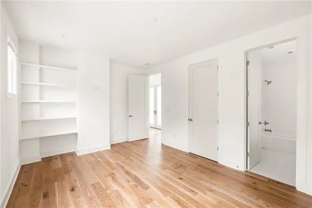 a view of empty room with wooden floor and entryway