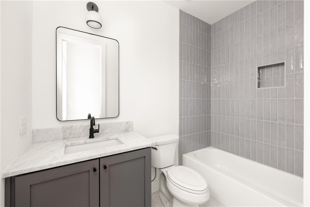 10904 Serenbe Lane Palmetto, GA 30268 - Photo 16 of 23 a bathroom with a sink a toilet and shower