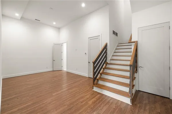 a view of a room with wooden floor and stairs