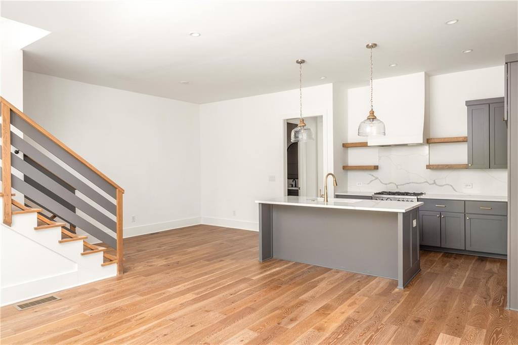 10904 Serenbe Lane Palmetto, GA 30268 - Photo 2 of 23 a kitchen with stainless steel appliances granite countertop a sink stove and refrigerator