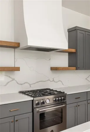 a stove top oven sitting inside of a kitchen
