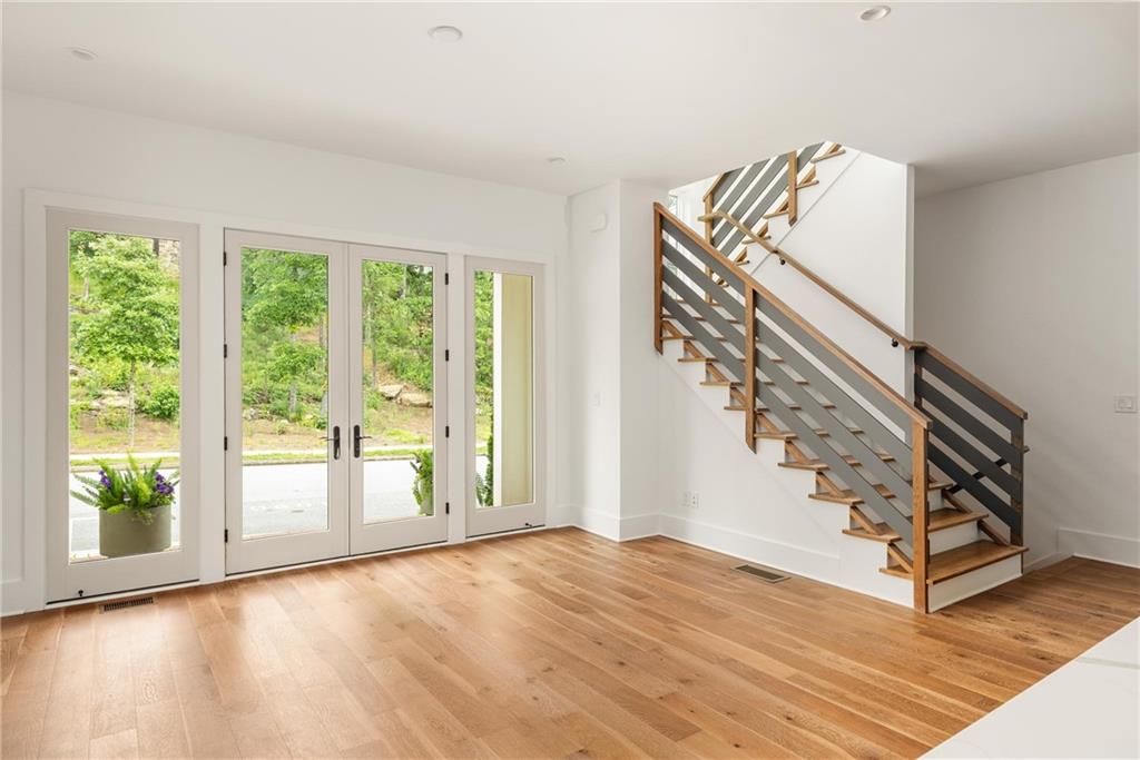 10904 Serenbe Lane Palmetto, GA 30268 - Photo 5 of 23 a view of an entryway with wooden floor and door