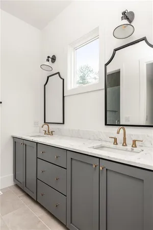 a bathroom with a double vanity sink and mirror