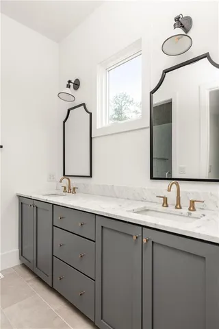 a bathroom with a double vanity sink and mirror