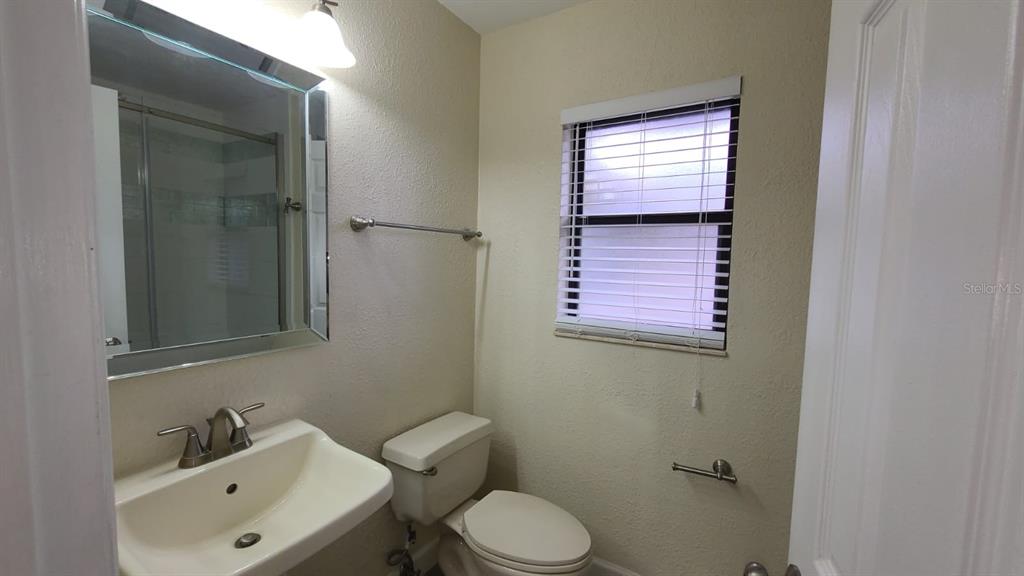399 Barberry Lane Altamonte Springs, FL 32714 - Photo 12 of 19 a bathroom with a toilet sink and mirror