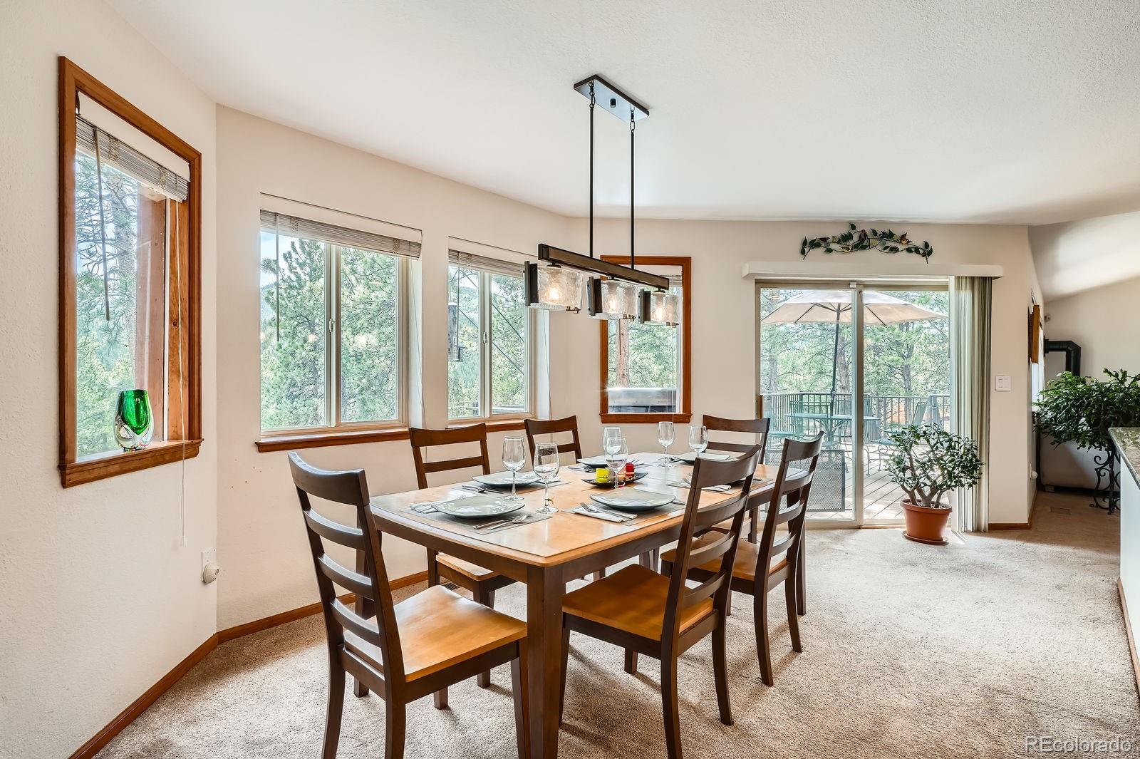 84 Marys Lane Bailey, CO 80421 - Photo 8 of 35 a view of a dining room with furniture window and wooden floor