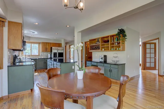 a dining room with furniture and wooden floor