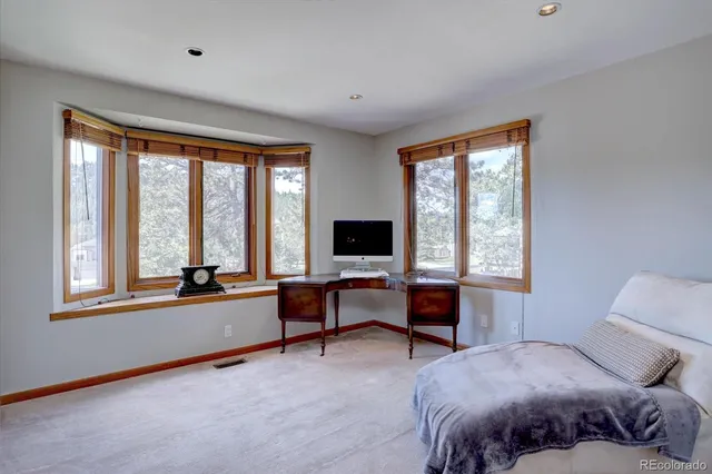 a bedroom with a large bed and a window