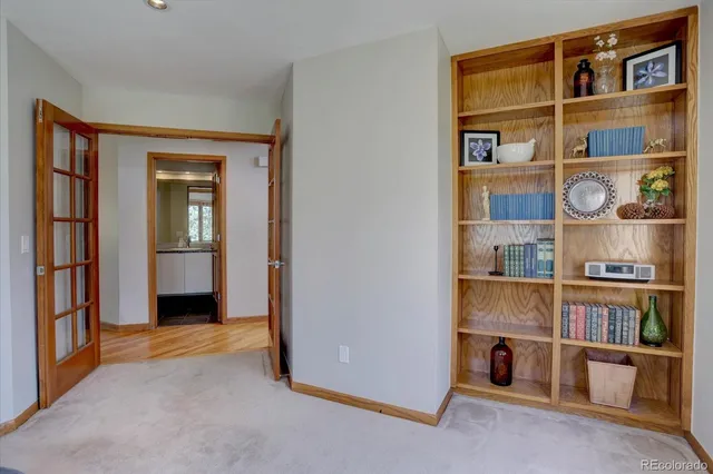 a view of a hardwood floor and a book shelf