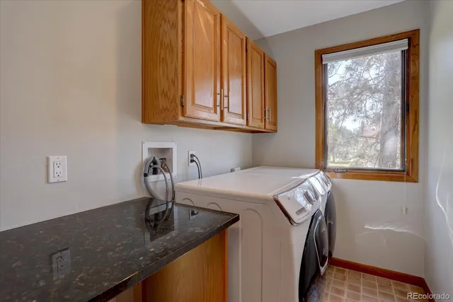 a kitchen with a sink a window and cabinets