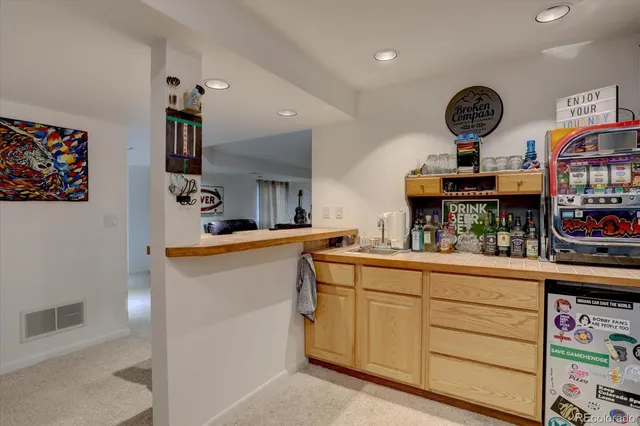 a bathroom with a granite countertop sink a mirror a toilet and shower