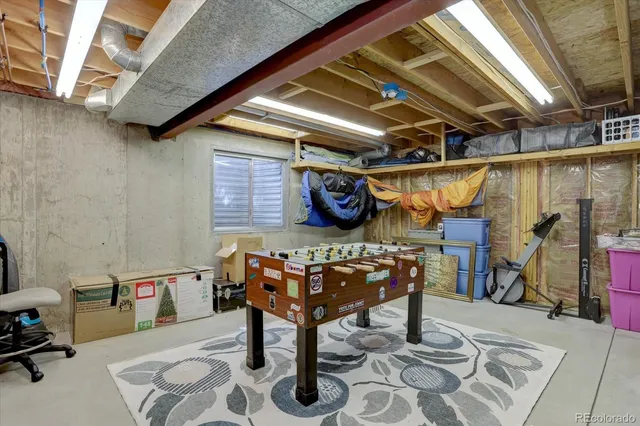 a view of a patio with table and chairs with wooden floor and fence