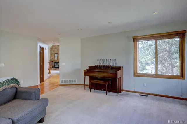 a living room with furniture and a piano