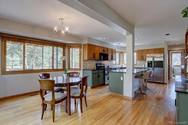 a dining room with furniture a window and wooden floor