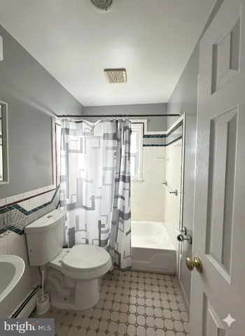 a bathroom with a toilet a sink and a bathtub