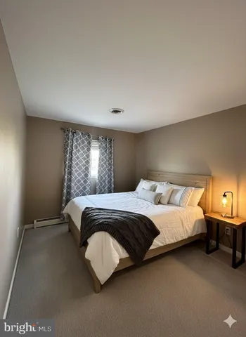 a spacious bedroom with a bed and window