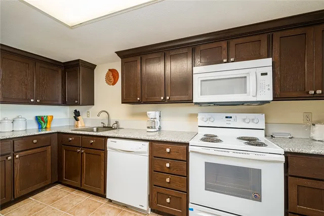 a kitchen with a sink stove and microwave
