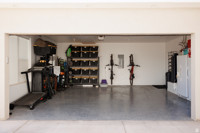 629 Spring Lily Drive St. George, UT 84790 - Photo 45 of 50 Spacious garage featuring a durable epoxy floor coating, white painted walls, and overhead lighting