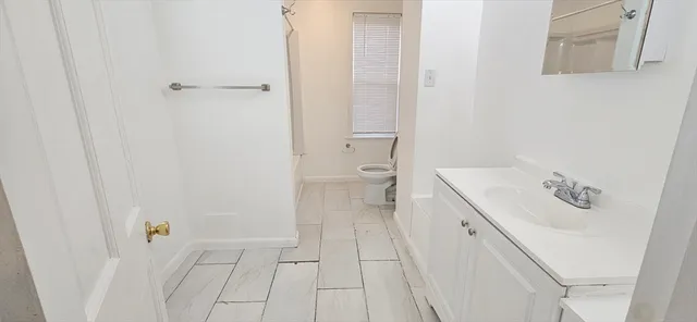 a bathroom with a sink a toilet and a shower