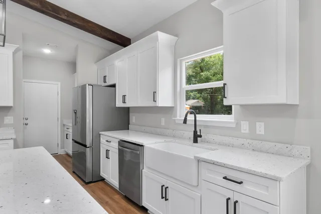 a kitchen with a sink cabinets and window