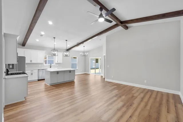 a view of kitchen with wooden floor and electronic appliances