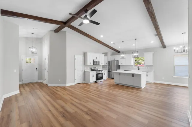 a view of a kitchen with microwave and cabinets