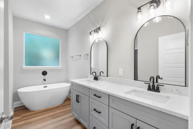 a bathroom with a double vanity sink and a mirror