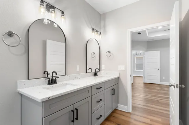 a bathroom with a double vanity sink and a mirror