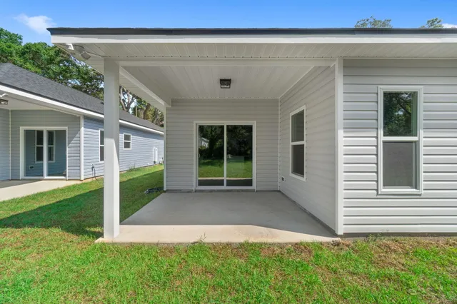 a view of a house with backyard and porch