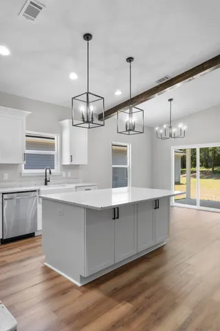 a large kitchen with kitchen island a large island in the center