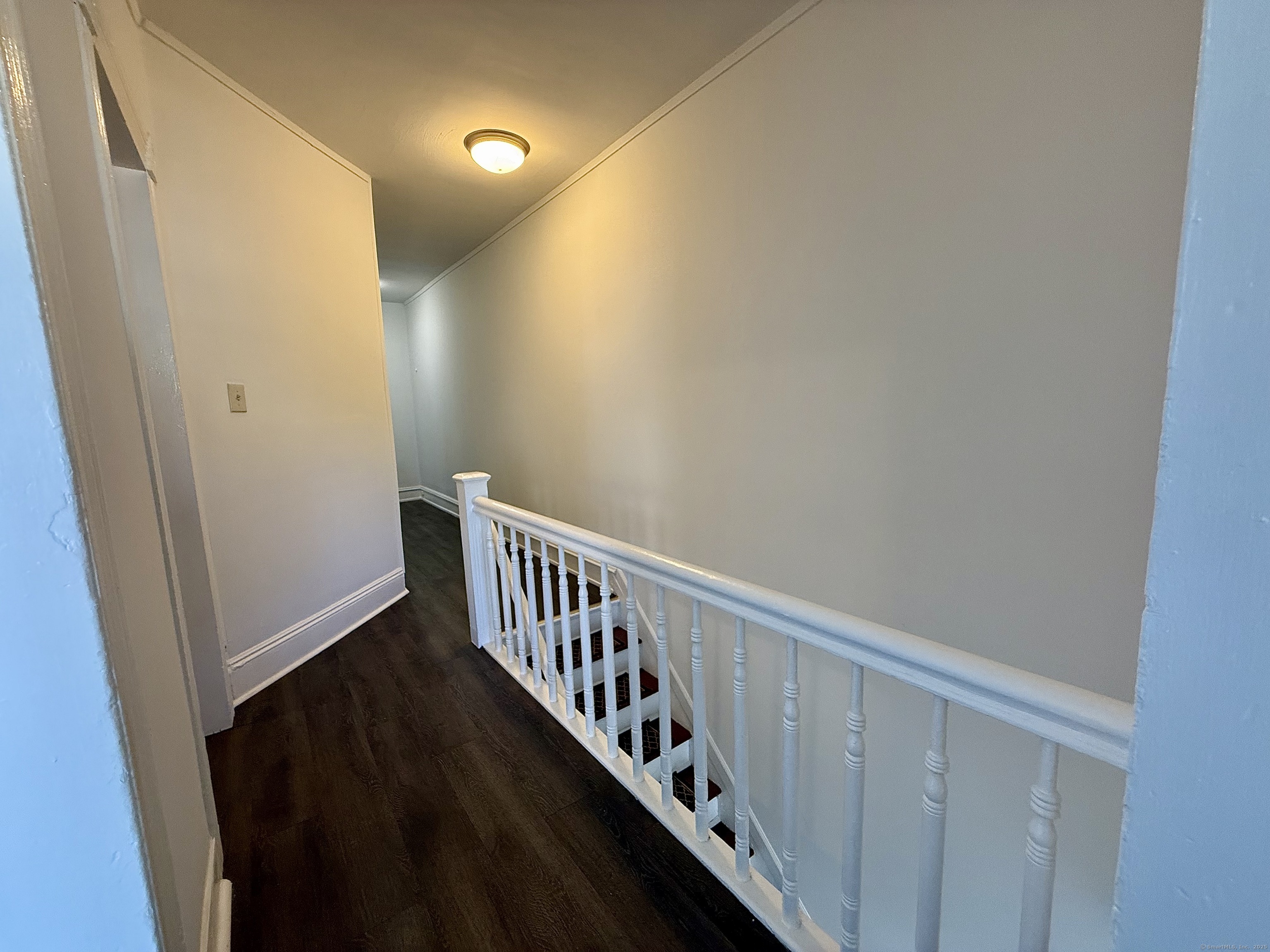 519 Brooks Street Bridgeport, CT 06608 - Photo 3 of 11 a view of a hallway with wooden floor