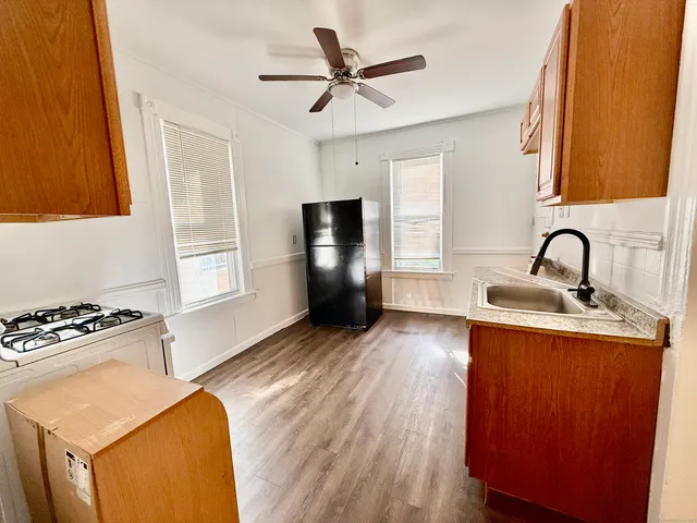 a kitchen with sink and refrigerator