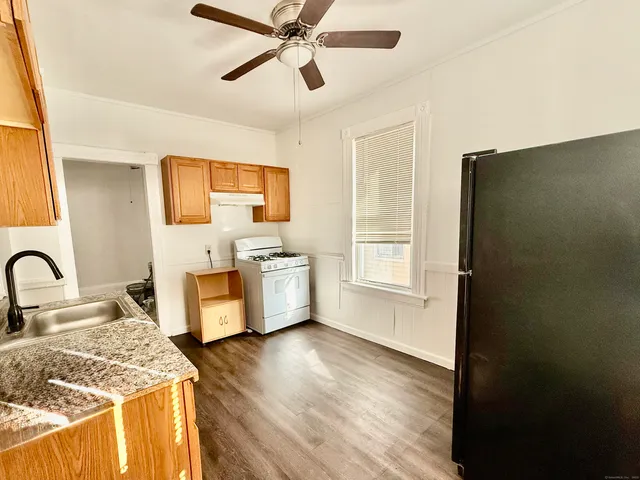 a view of a kitchen with a sink cabinets and wooden floor