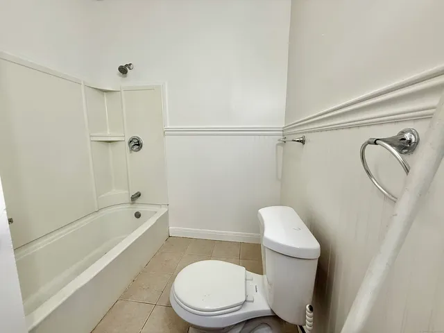 a bathroom with a toilet and a shower