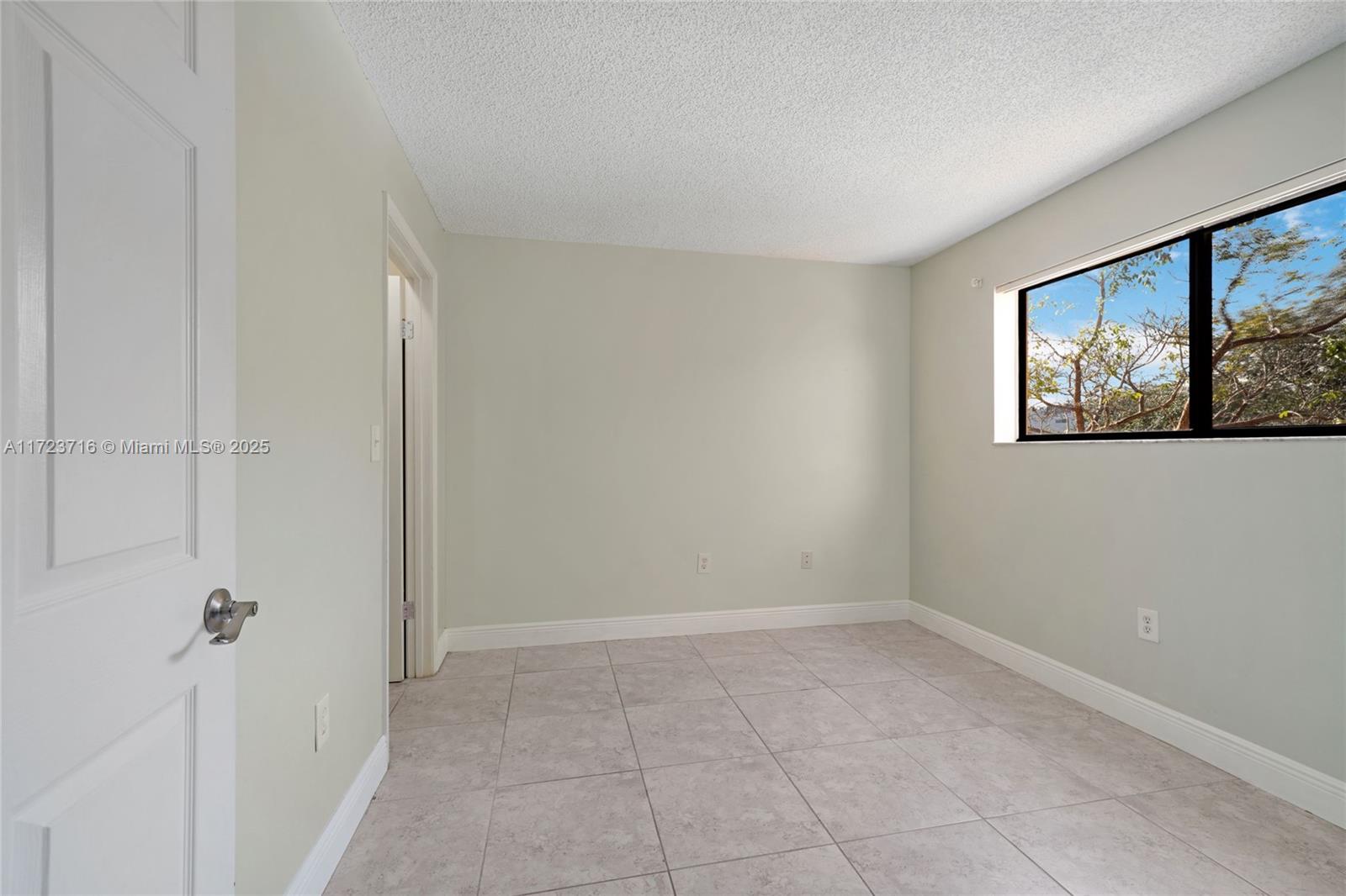 7451 Northwest 16th Street, Unit 210 Plantation, FL 33313 - Photo 18 of 40 a view of an empty room with a window