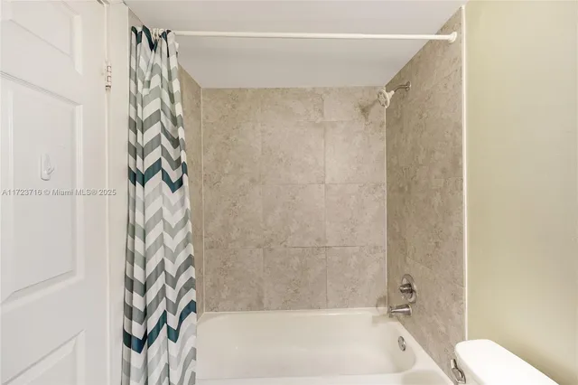 a bathroom with a shower curtain and a shower curtain