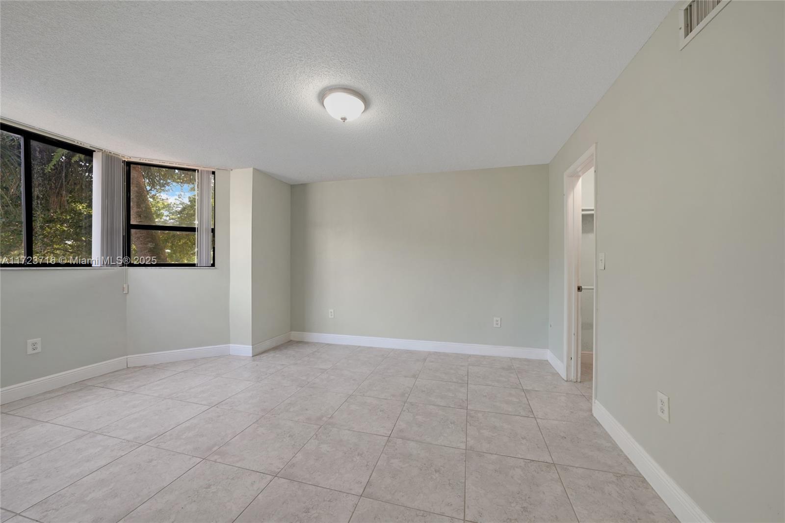 7451 Northwest 16th Street, Unit 210 Plantation, FL 33313 - Photo 23 of 40 an empty room with windows and closet