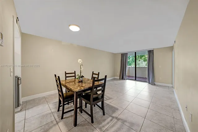 a view of a dining room with furniture and a potted plant
