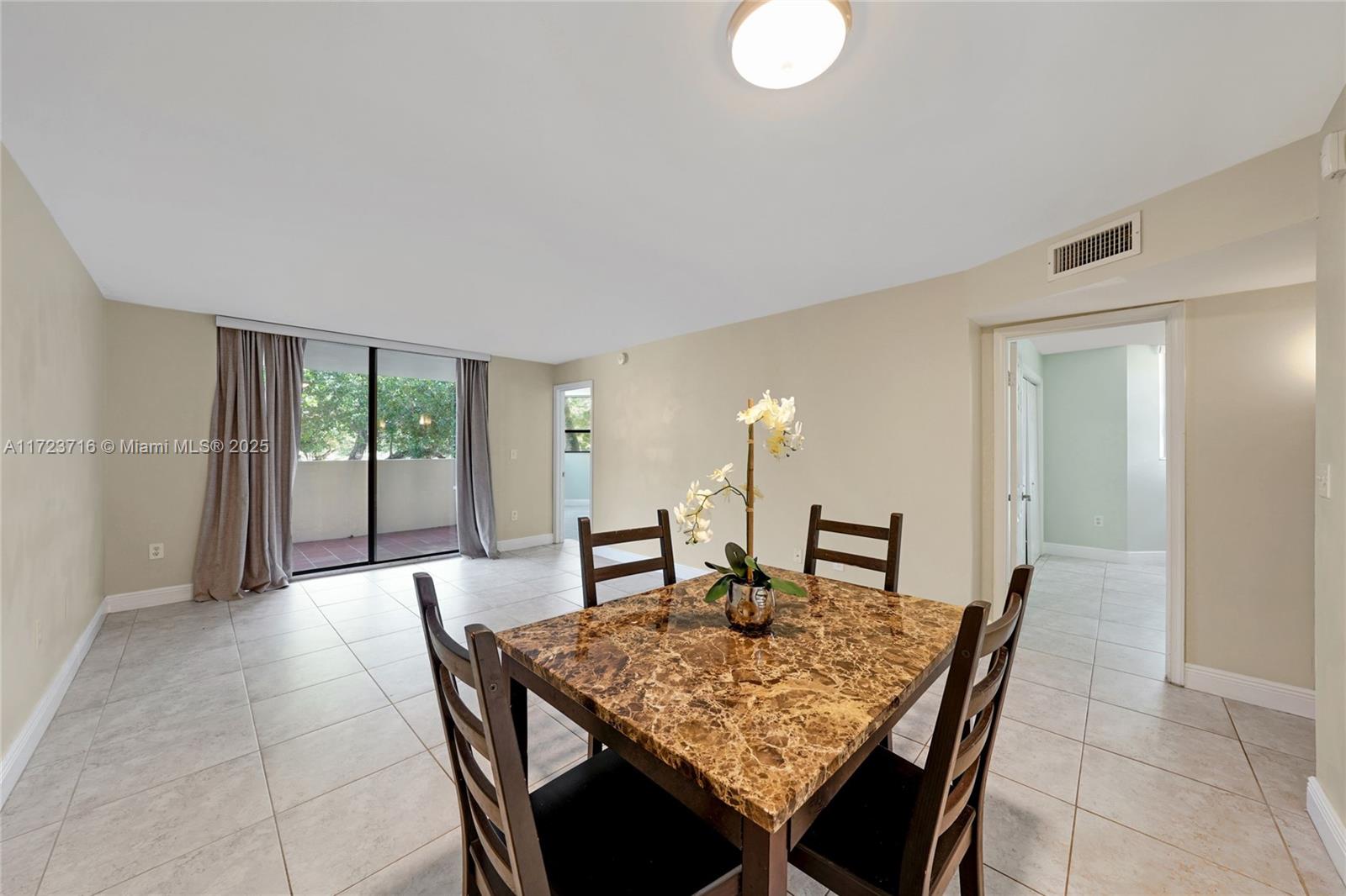 7451 Northwest 16th Street, Unit 210 Plantation, FL 33313 - Photo 10 of 40 a dining room with a table and chairs