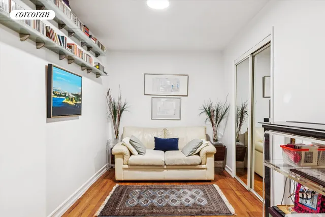 a living room with furniture and a book shelf