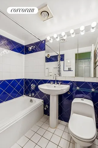 a bathroom with a sink a toilet and mirror