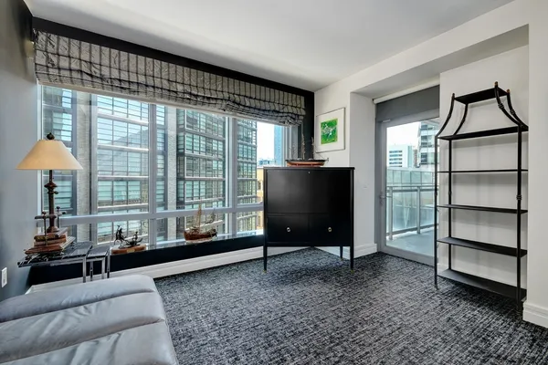 a living room with furniture a window and a flat screen tv
